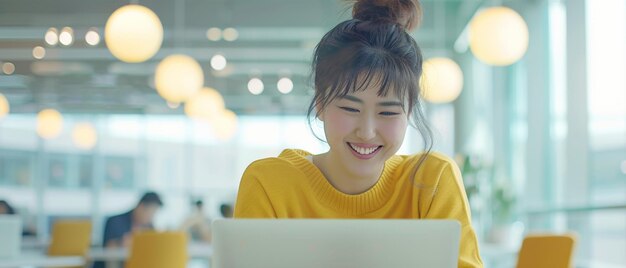 A woman39s delighted laughter while working on her laptop highlights joy in her work