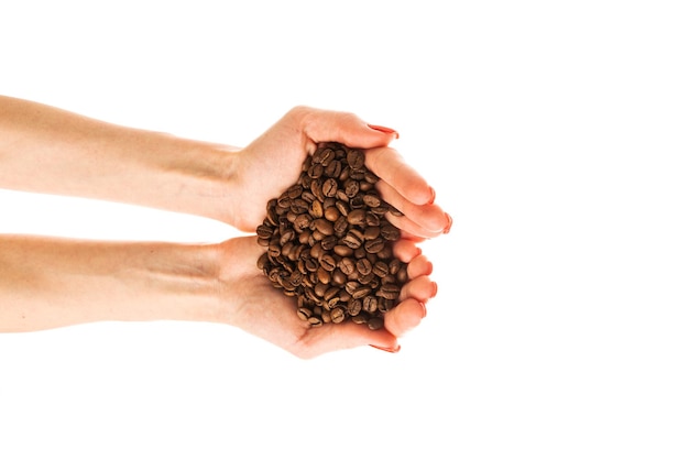 Woman39s hands with red nails holding coffee beans