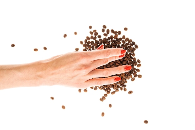 Woman39s hands with red nails holding coffee beans