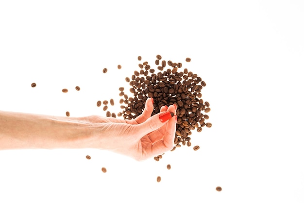 Woman39s hands with red nails holding coffee beans