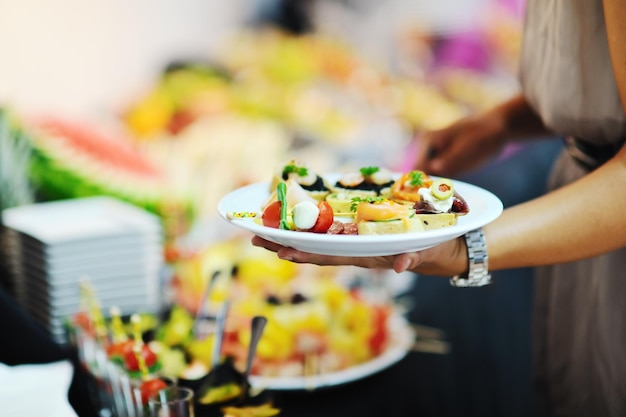 womanl chooses tasty meal in buffet at hotel  banquet party restaurant