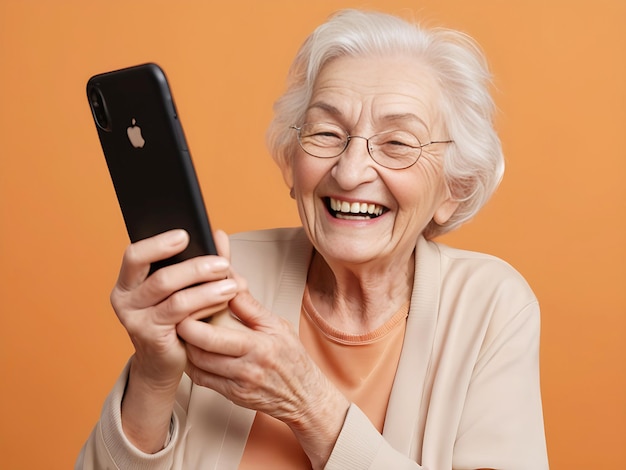 Womans day beautiful elderly woman smiling and laughing with her phone against an orange background