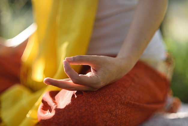 Womans hand in mudra posture outdoors