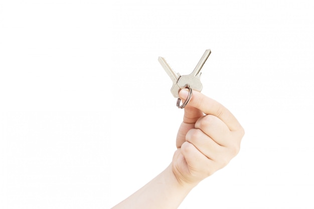 Womans hand with metal key. Keys in hand on white background. Isolated on white 