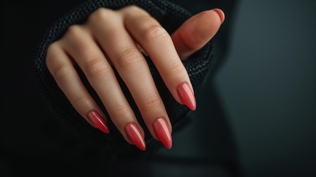 A womans hand with a neat pink manicure