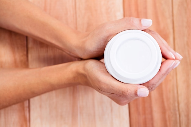 Womans hands holding cup of coffee