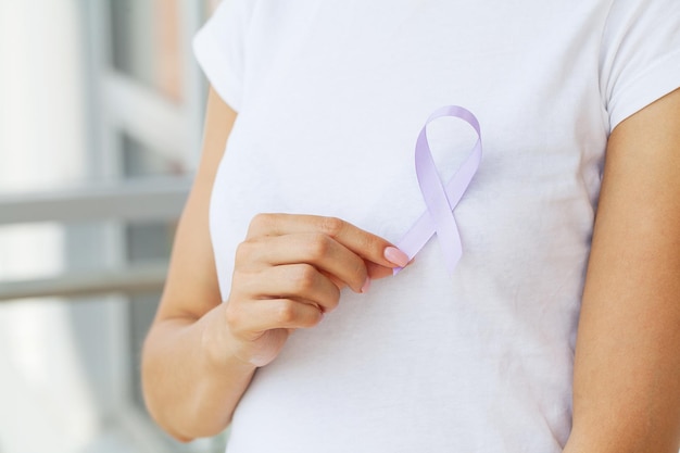 Womans hands holding purple domestic violence awareness ribbon