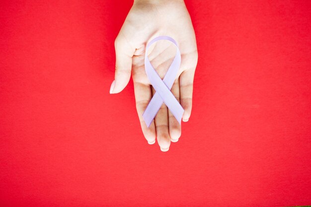 Womans hands holding purple domestic violence awareness ribbon