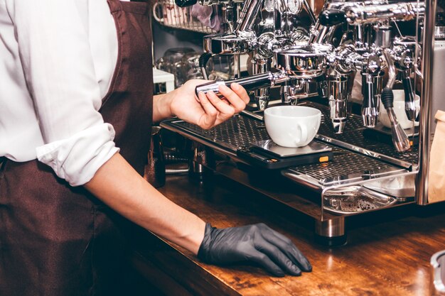 Women Barista using coffee machine