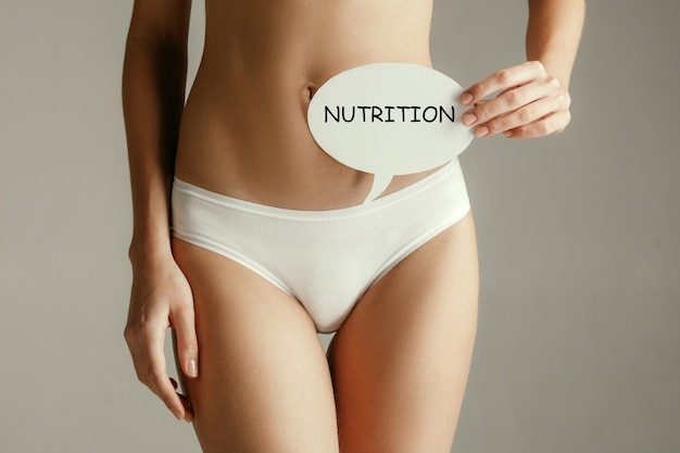 Women belly with the drawing word nutrition