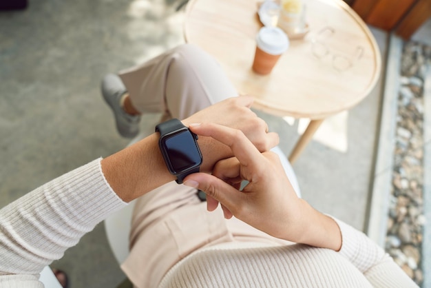 Women checking smartwatch on her hand