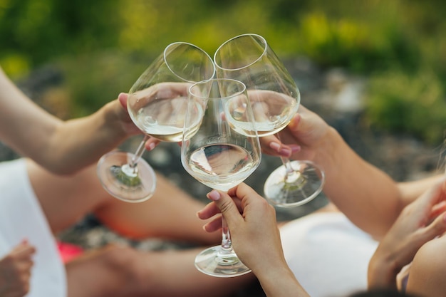 Women clink glasses with white wine