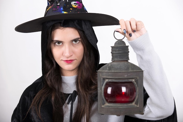 Women dressed as witches holding lanterns on Halloween day