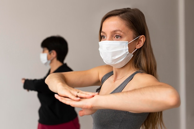 Women exercising with face masks