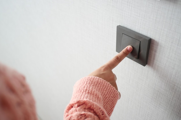 Women finger turning on lighting switch