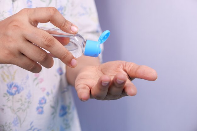 women hand using sanitizer gel for preventing virus with copy space