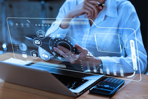 Women hand working with tablet and laptop computer tablet in modern office with virtual icon diagram at modern office