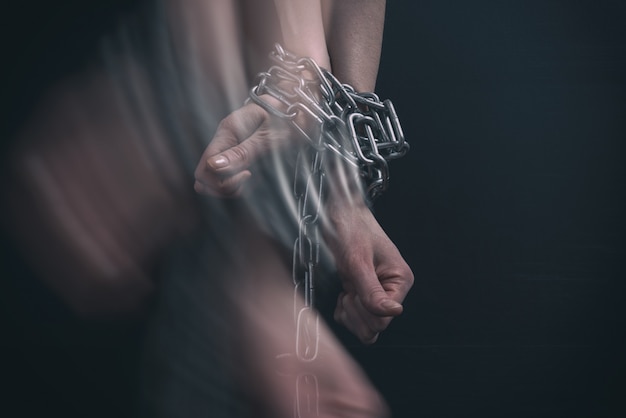 Women hands chained, break out in motion