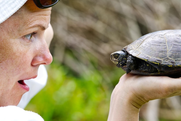 Photo women hold european turtle close up portrait women at the turtle sanctuary hatchery