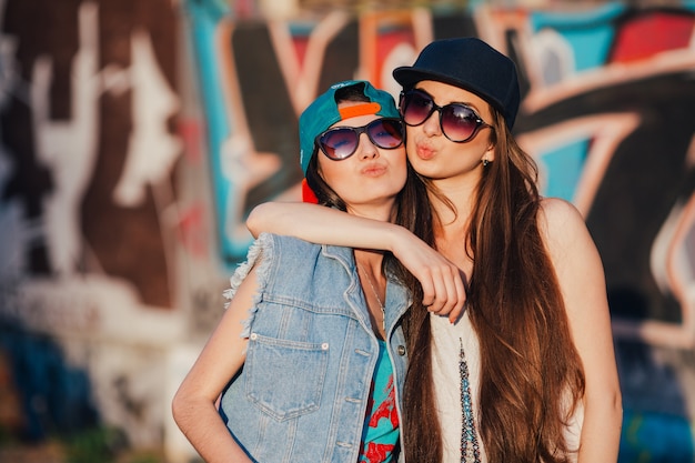 Women hugging at graffiti