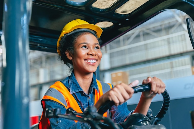 Women labor worker at forklift driver happy smile enjoy working in industry factory logistic shipping warehouse