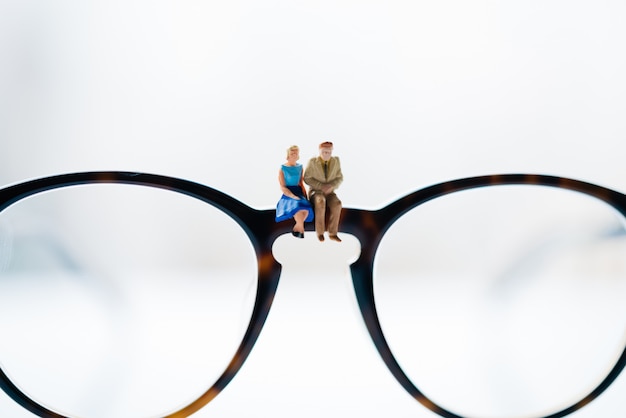 A women and a man in love sitting on glasses with city backgrounds.