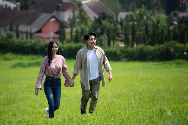 Women and men holding hands walking on the natural grass