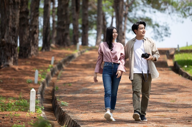 Women and men holding hands walking on the natural grass