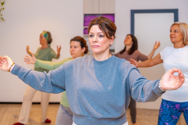 Women opening arms during qi gong class