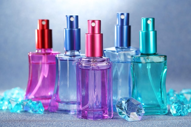 Women perfume in beautiful bottles on bright background