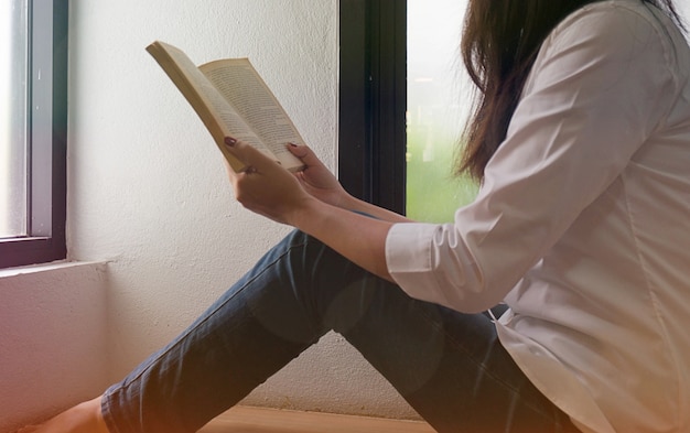 women reading book and relaxing in her living room.selective focus