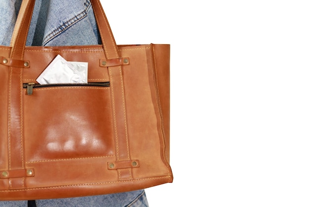 Women's brown bag with two condoms in the pocket