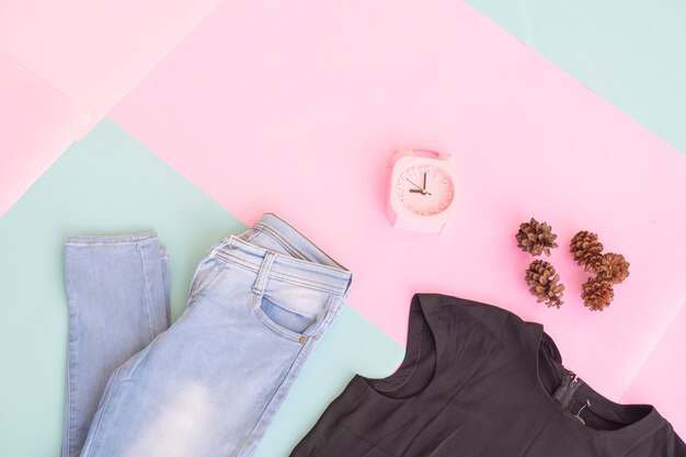 Women's clothing base layout, Outer on pale mint pastel background. Lifestyle concept. alarm clock. small bag. bag