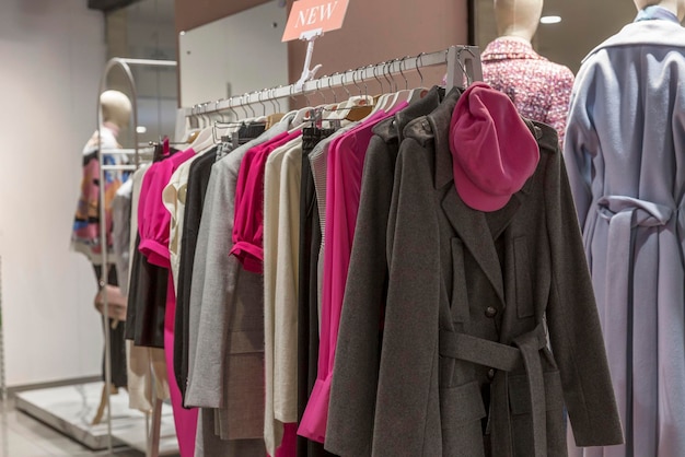 Women's coats in different colors in a clothing store New autumn collection Selective focus