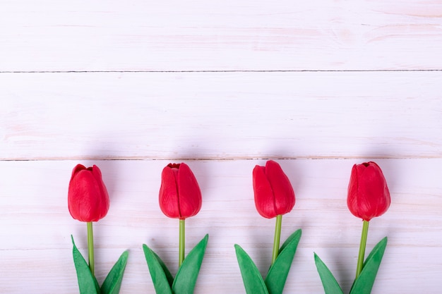 Women's day, Mother's day, Valentine's day concept Red tulips bouquet and a gift 