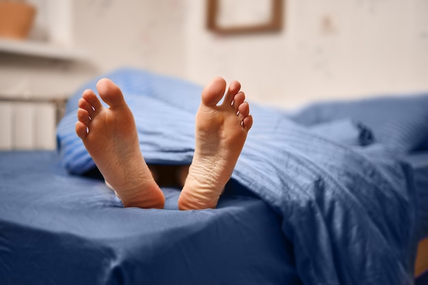 Women's feet on the bed