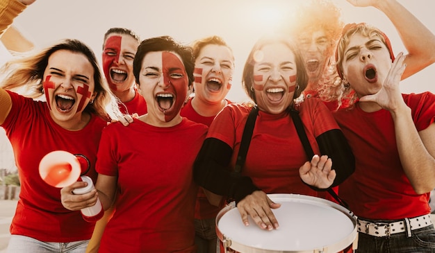 Women's football fans having fun cheering for their favorite team