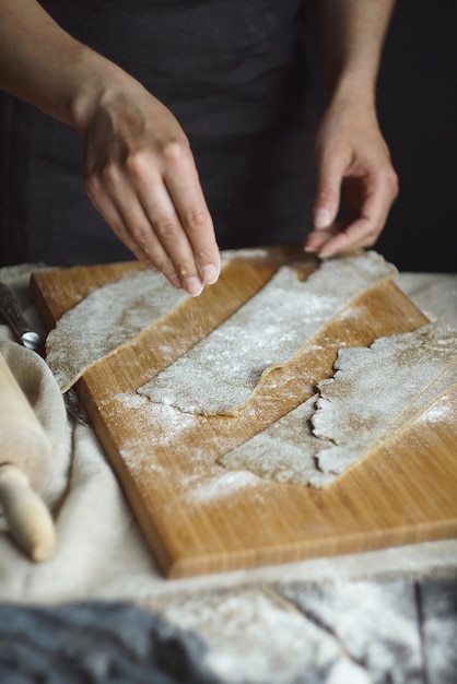 Women's hands are preparing home-made raw noodles, Rustic, Selective Focus, Atmospheric dark tone