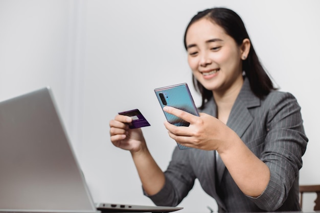 Women's hands holding a credit card and work on laptop Online payment for online shopping