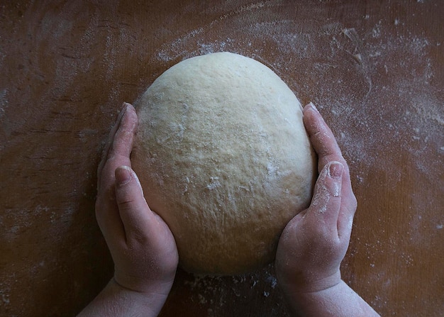 Women's hands knead the dough 3