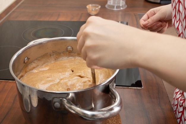 Women's hands prepare gingerbread, cookies, add butter