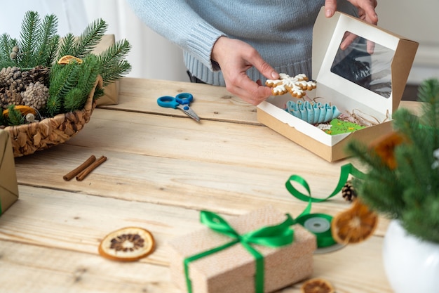 women's hands put cookies in a box