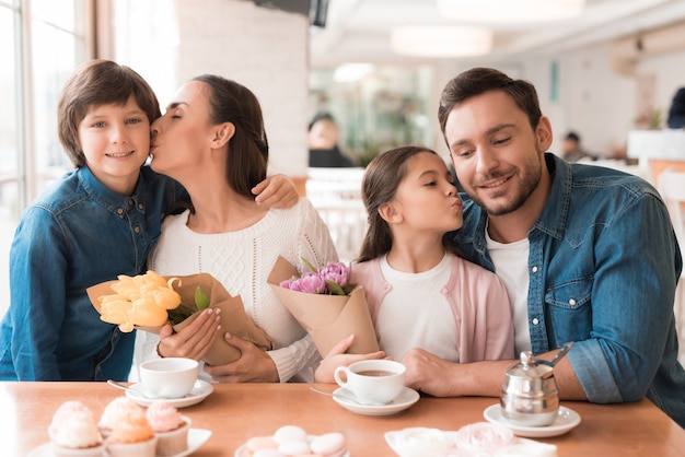 Women's Holiday in Cafe Happy Family with Flowers.