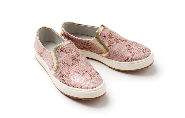 Women's pink crocodile leather loafers with thick white soles A new pair of shoes on a white background