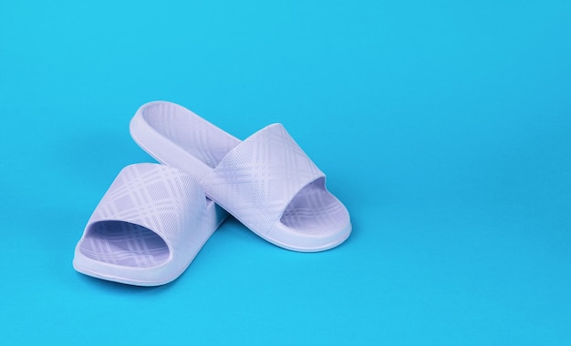 Women's summer purple flipflops on a light blue background