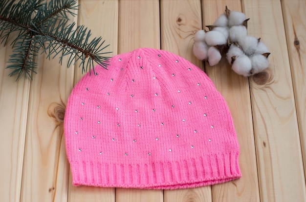 Women's winter warm knitted hat with a pompom Green spruce twig