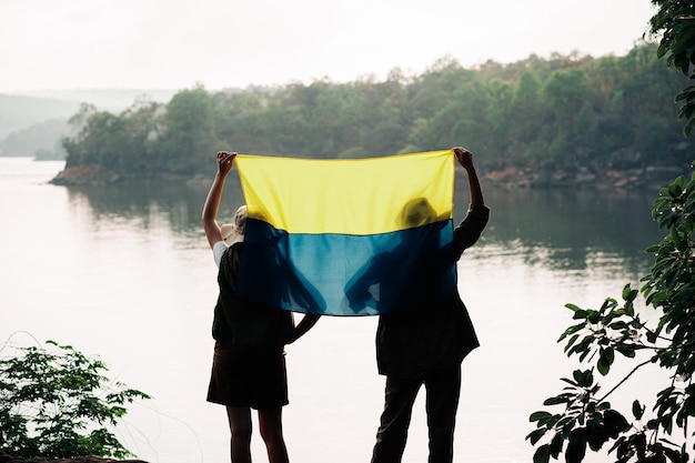 Women standing and holding the Ukraine flag Save Ukraine stop war