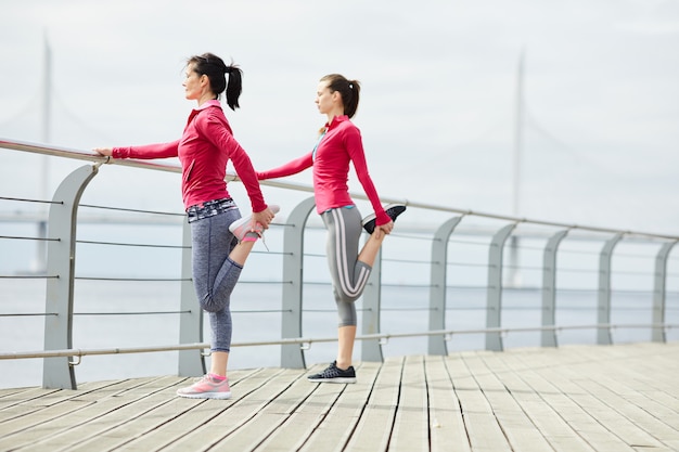 Women Stretching on Pier