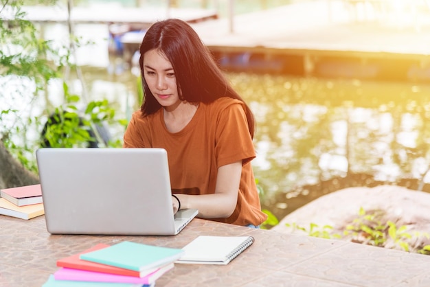 Women students are using computer laptop outdoor, Education concept