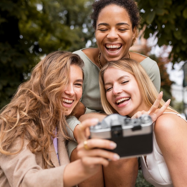 Women taking a selfie with a vintage camera